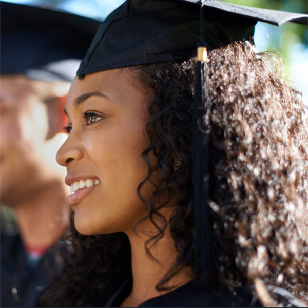 smiling woman graduating with cap and gown