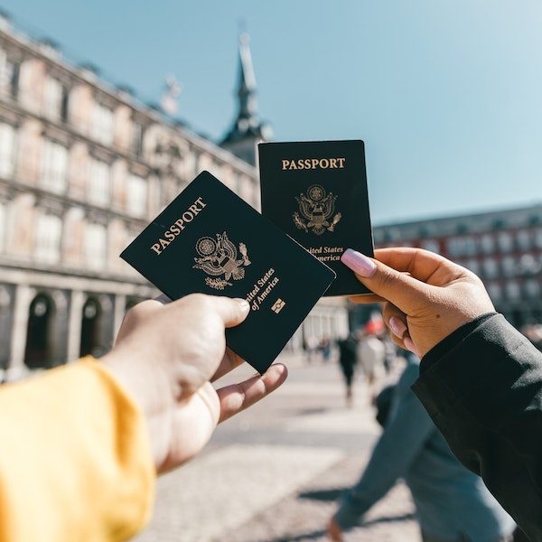 people holding up their passports for a selfie